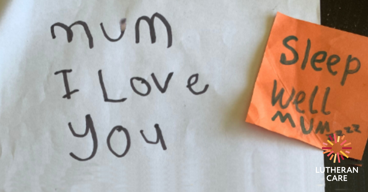 A handwritten note from a child reads mum i love you with a post it not say sleep well mum stuck on it. The Lutheran Care logo appears in the bottom right hand corner.