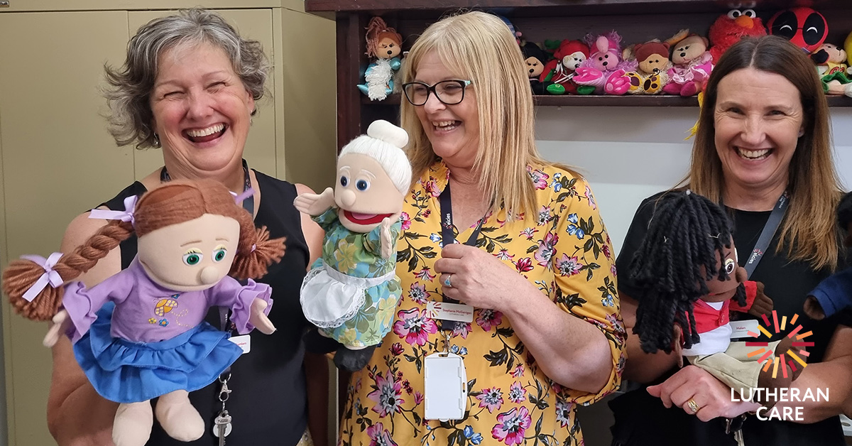 Three Lutheran Care staff members have fun with puppets in the new Children's Contact Service space.