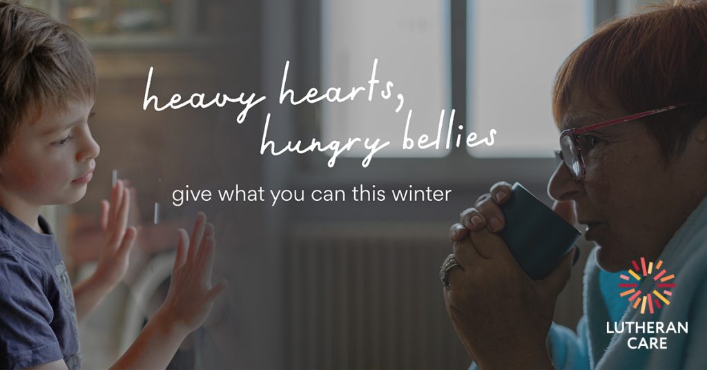 Image of a young boy looking out the window and an older woman in a dressing gown drinking a hot drink to keep warm. Text reads heavy hearts hungry bellies give what you can this winter. Lutheran Care logo appears in the bottom right hand corner.