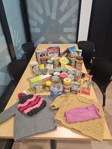 Donated cans of food, dry goods and clothing for Winter Woollies
