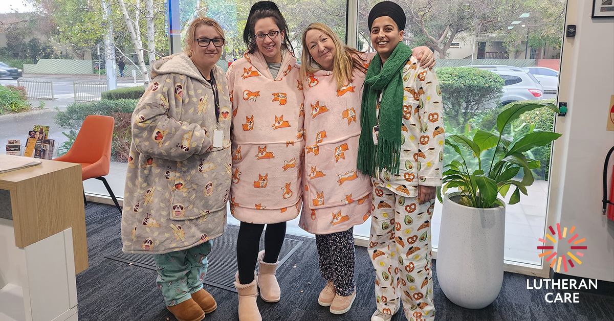 Four Lutheran Care staff in oodies, pajamas and ugg boots for Winter Woollies Day 2023