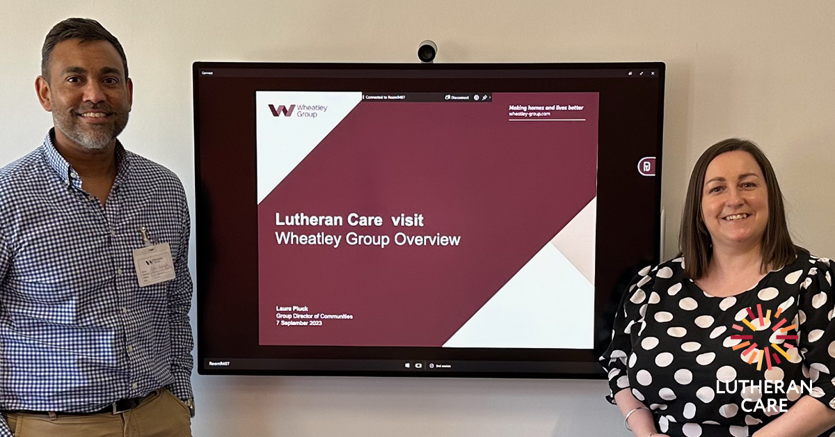 Lutheran Care CEO Rohan Feegrade with Wheatley Group Staff member. The Lutheran Care logo appears in the bottom right hand corner.