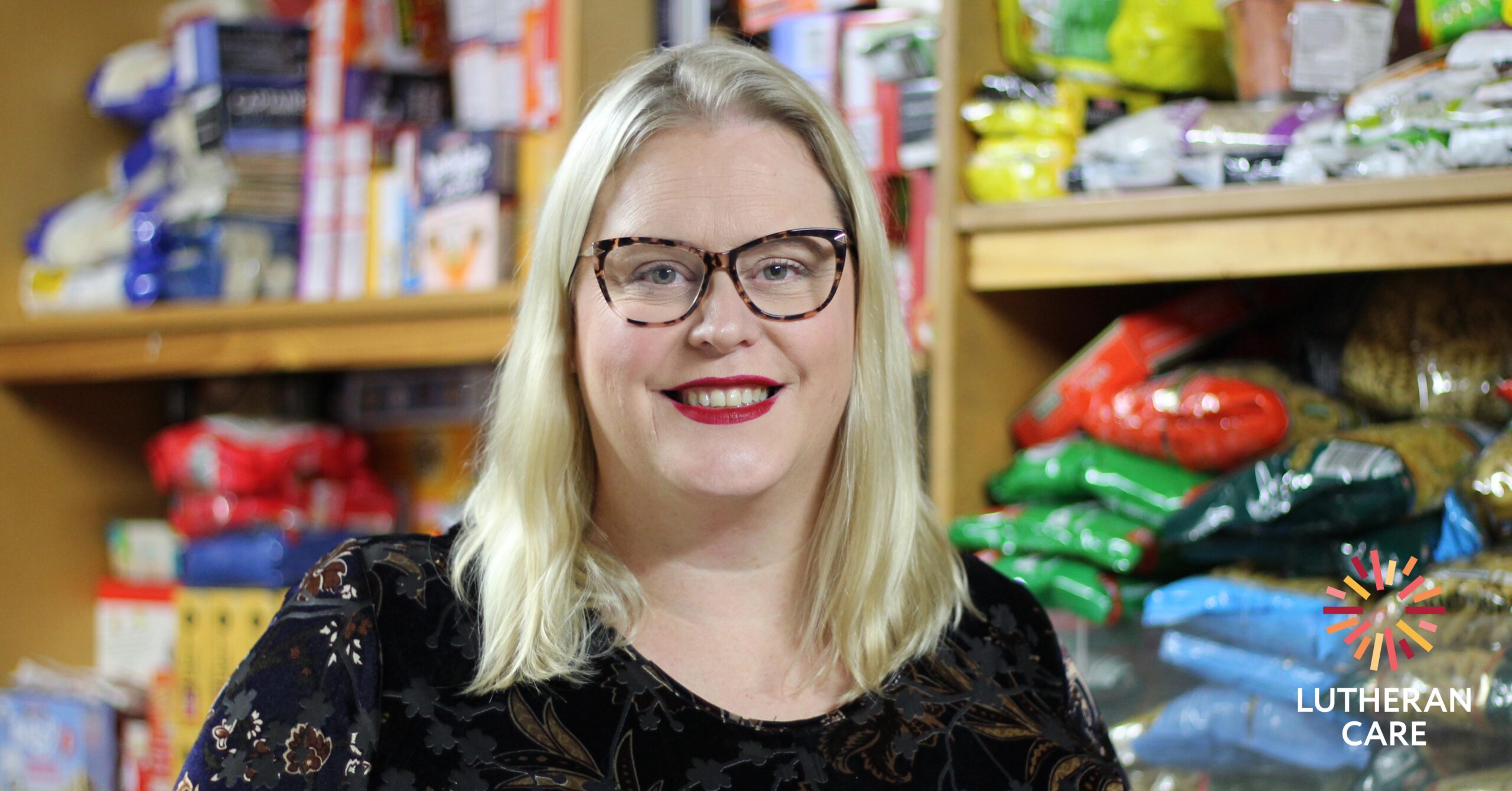 Kelly in the Blair Athol Emergency Relief pantry. The Lutheran Care logo appears in the bottom right hand corner.