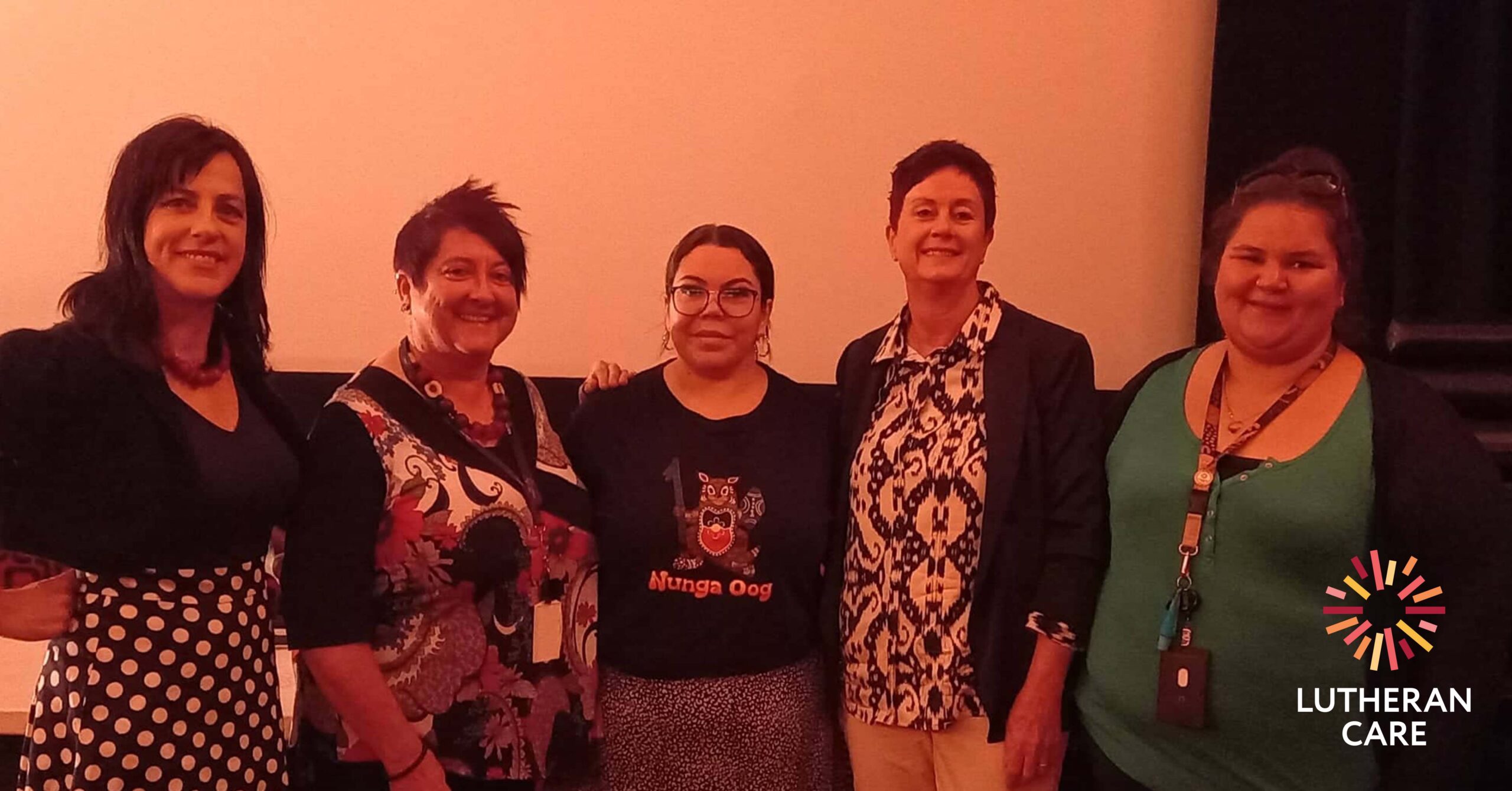 Lutheran Care staff at the screening. The Lutheran Care logo appears on the lower right hand side of the image.