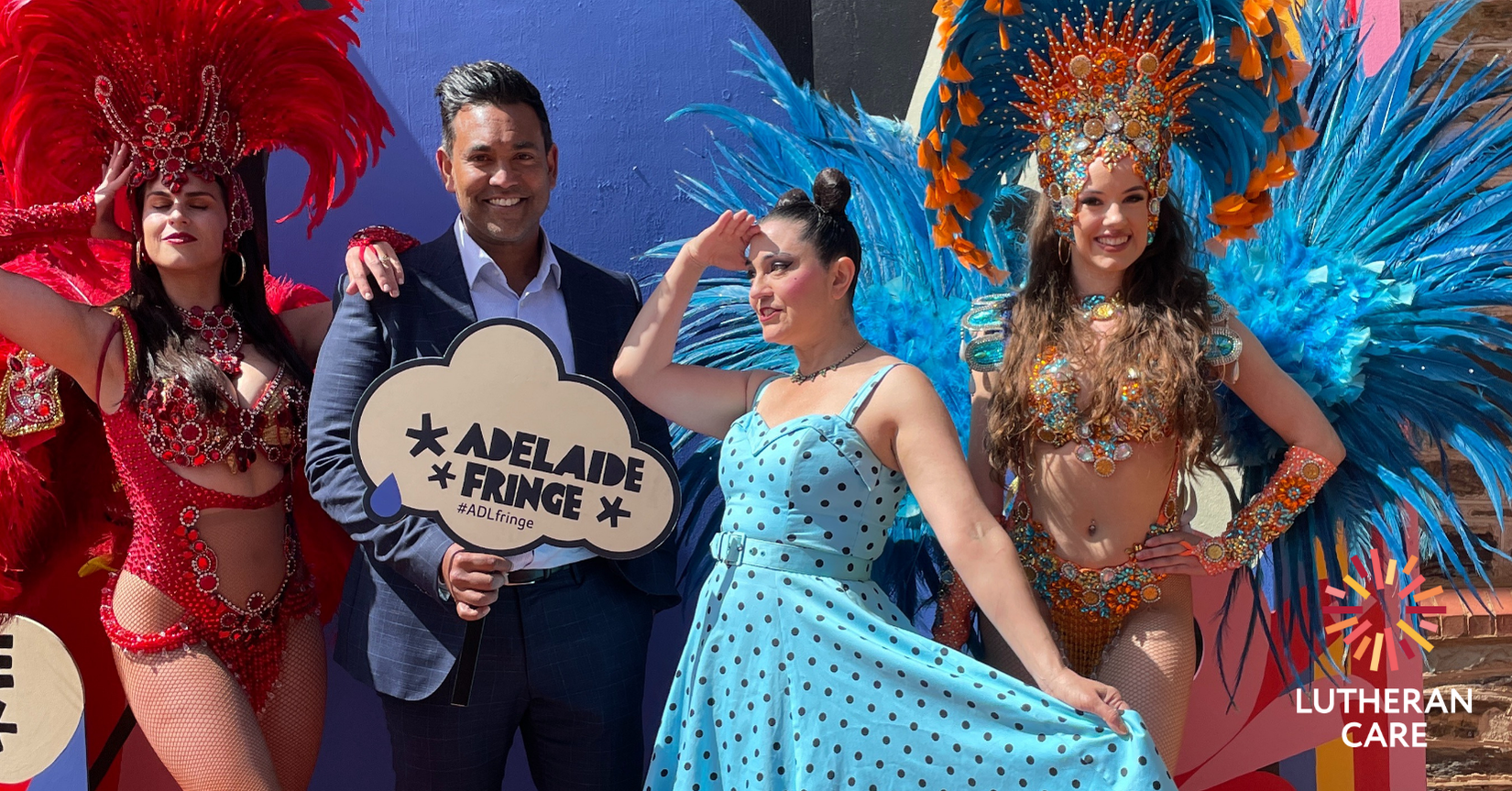 Image of Lutheran Care CEO Rohan Feegrade with Fringe performers. The Lutheran Care logo appears in the bottom right hand corner.