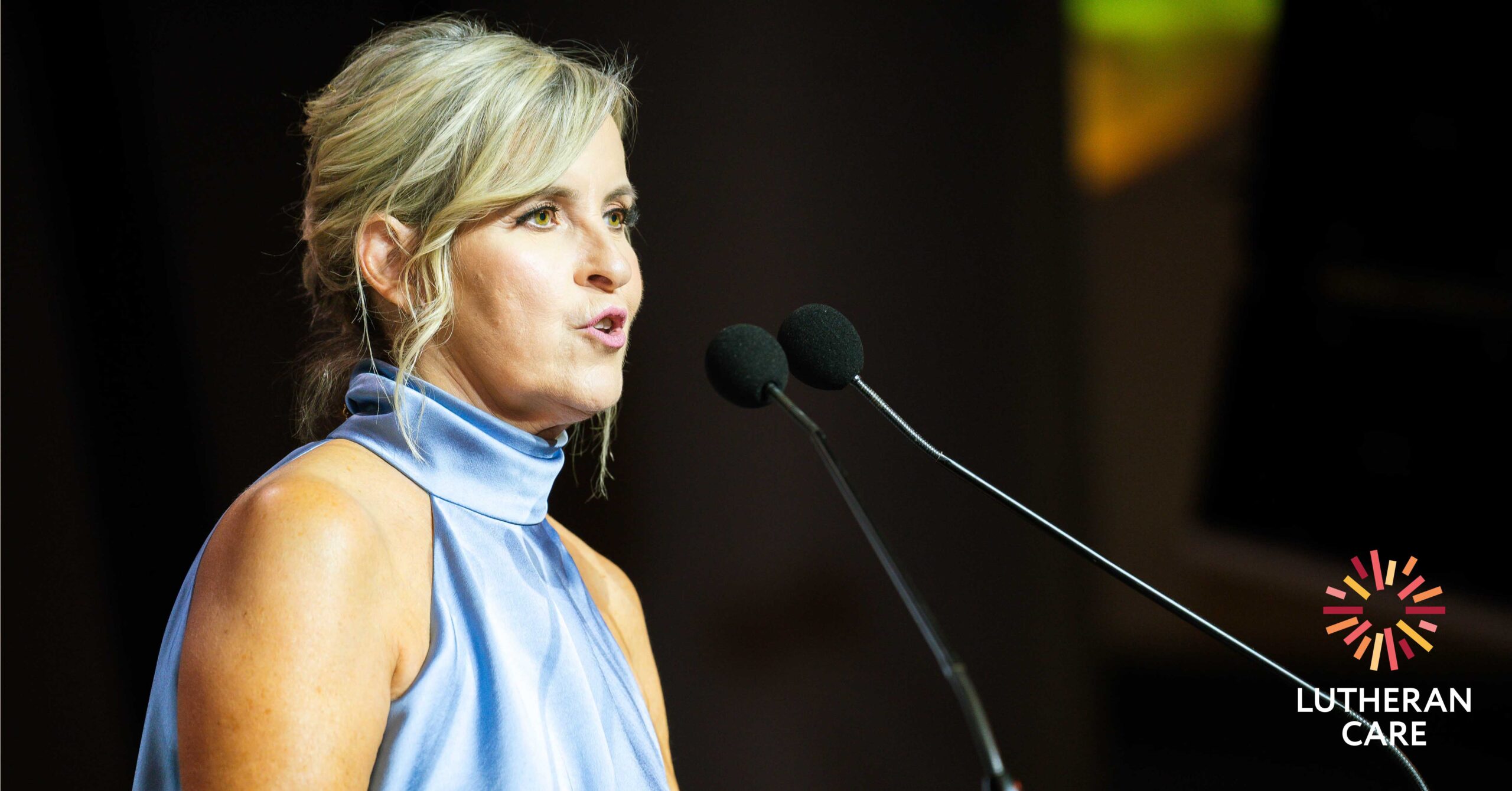 Image of Sandy speaking at the Lutheran Care Gala Dinner in 2023. The Lutheran Care logo appears in the bottom right hand corner.