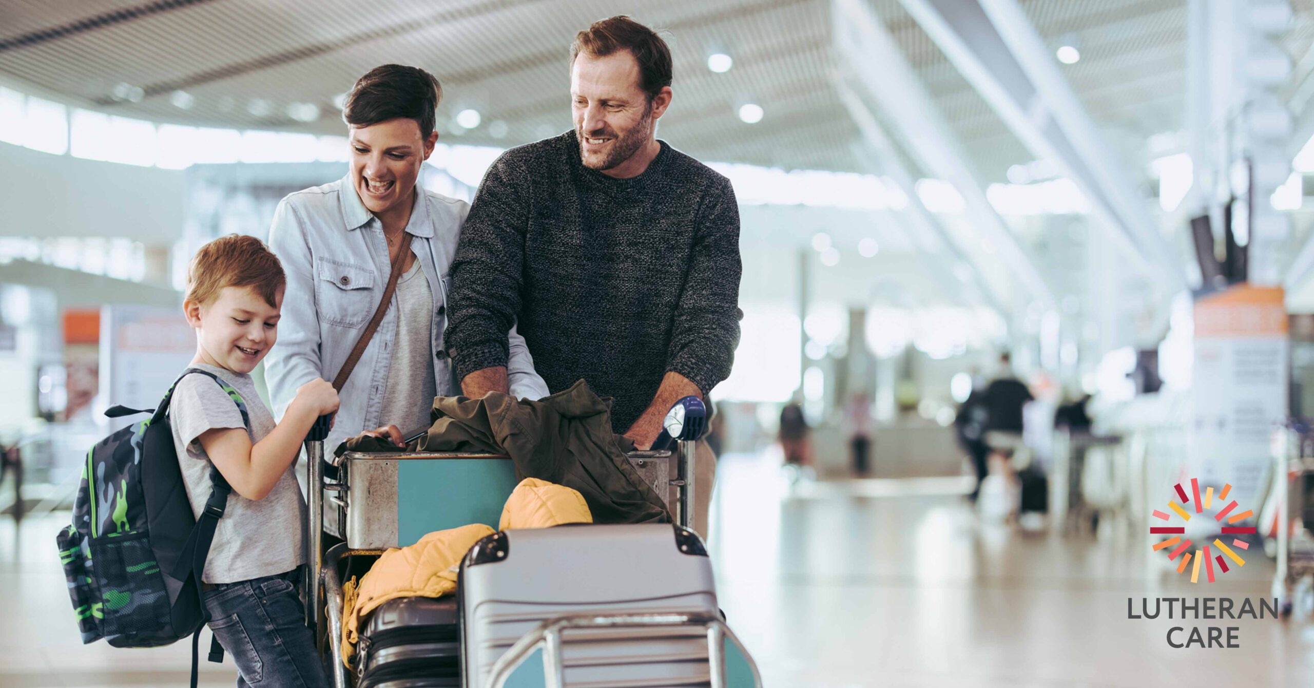 A family at the airport. The Lutheran Care logo appears in the bottom right hand corner.