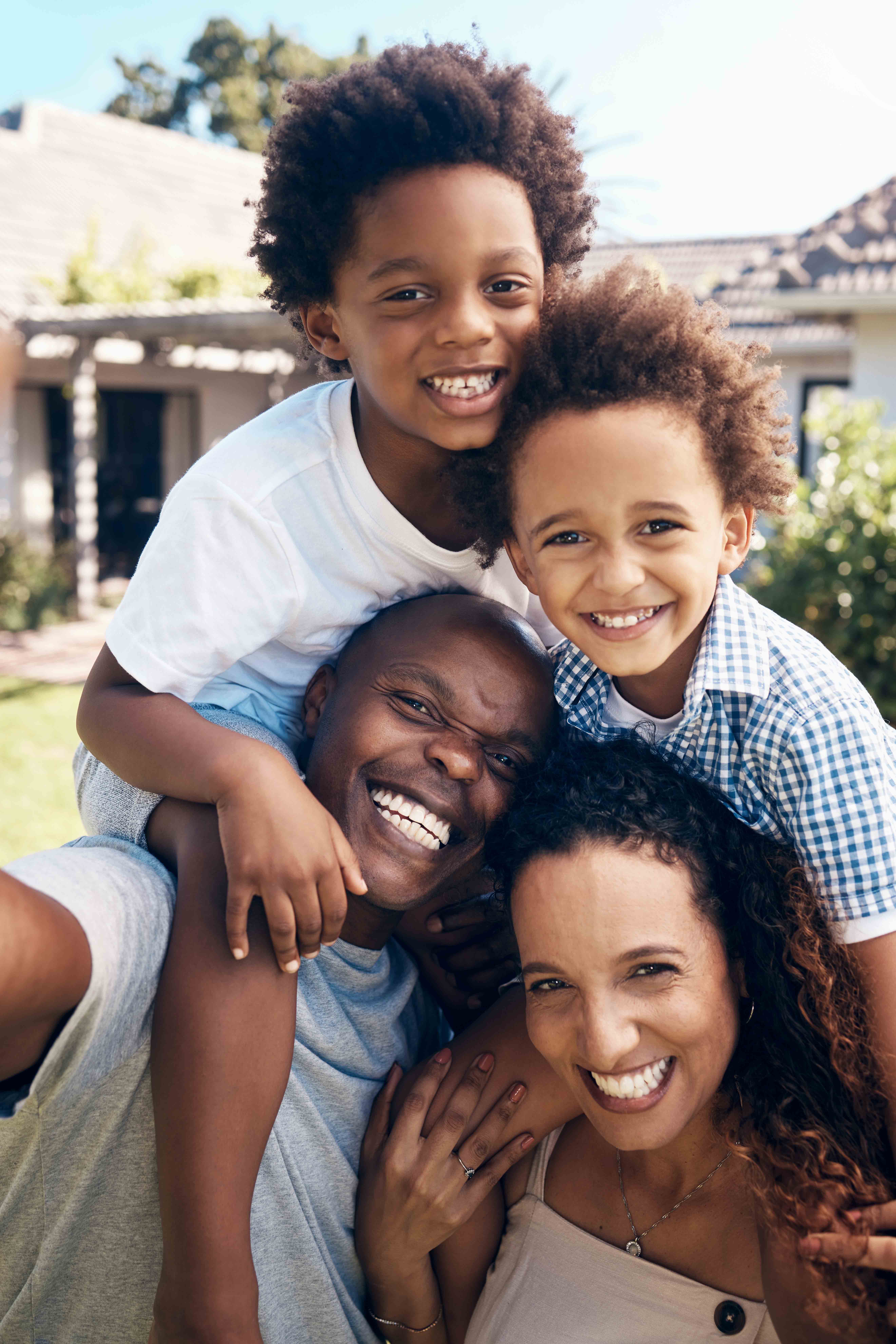 Happy young family smile at camera outside.