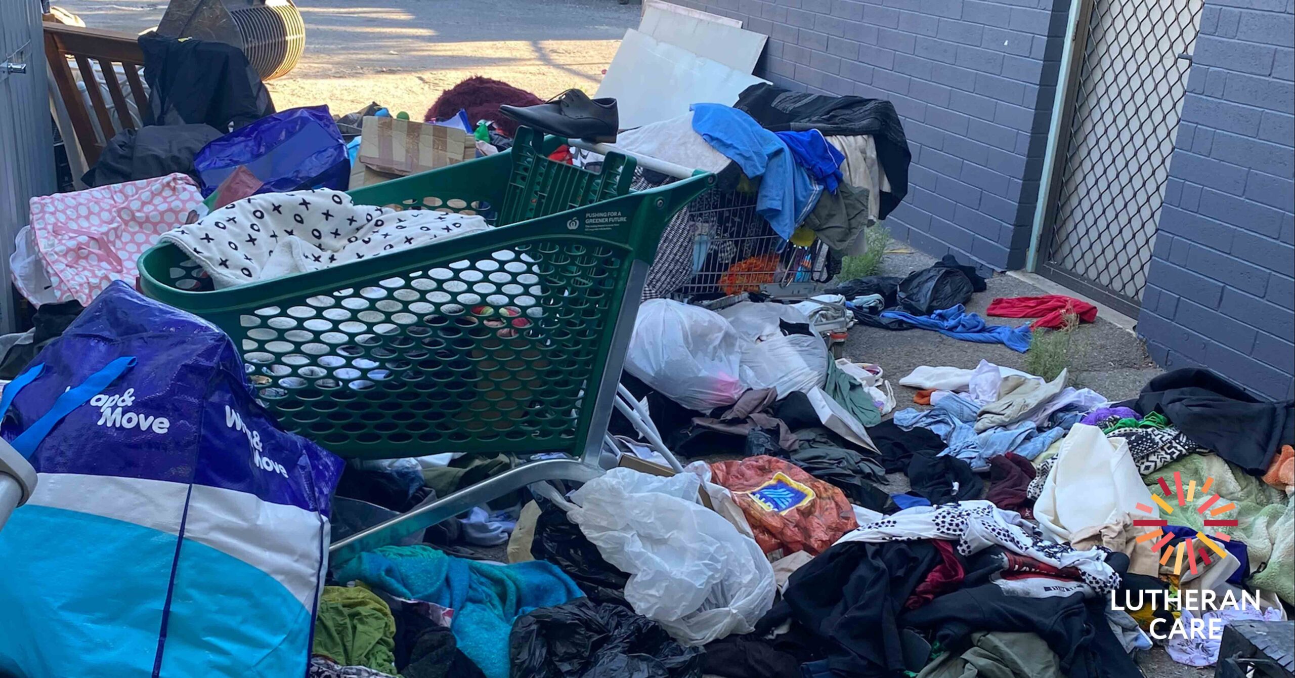Image of donations and dumping of items on the ground outside the Salisbury op shop. The Lutheran Care logo appears in the bottom right hand corner.