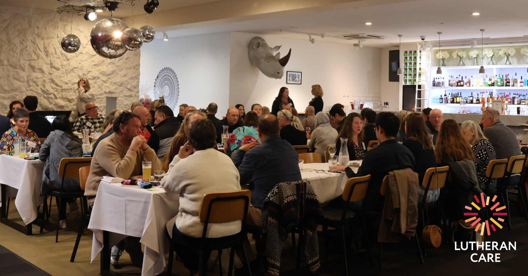 Carers at the appreciation lunch. The Lutheran Care logo appears in the bottom right hand corner.