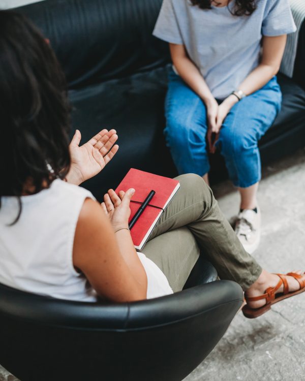 Psychotherapy session, woman talking to his psychologist in the studio