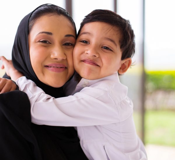 cute muslim boy hugging his mother